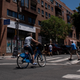 A bicyclist and pedestrians cross the intersection of South and 3rd Streets in Philadelphia, Pennsylvania.